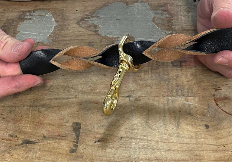Swivel bolt snap slid on braided leather dog lead.