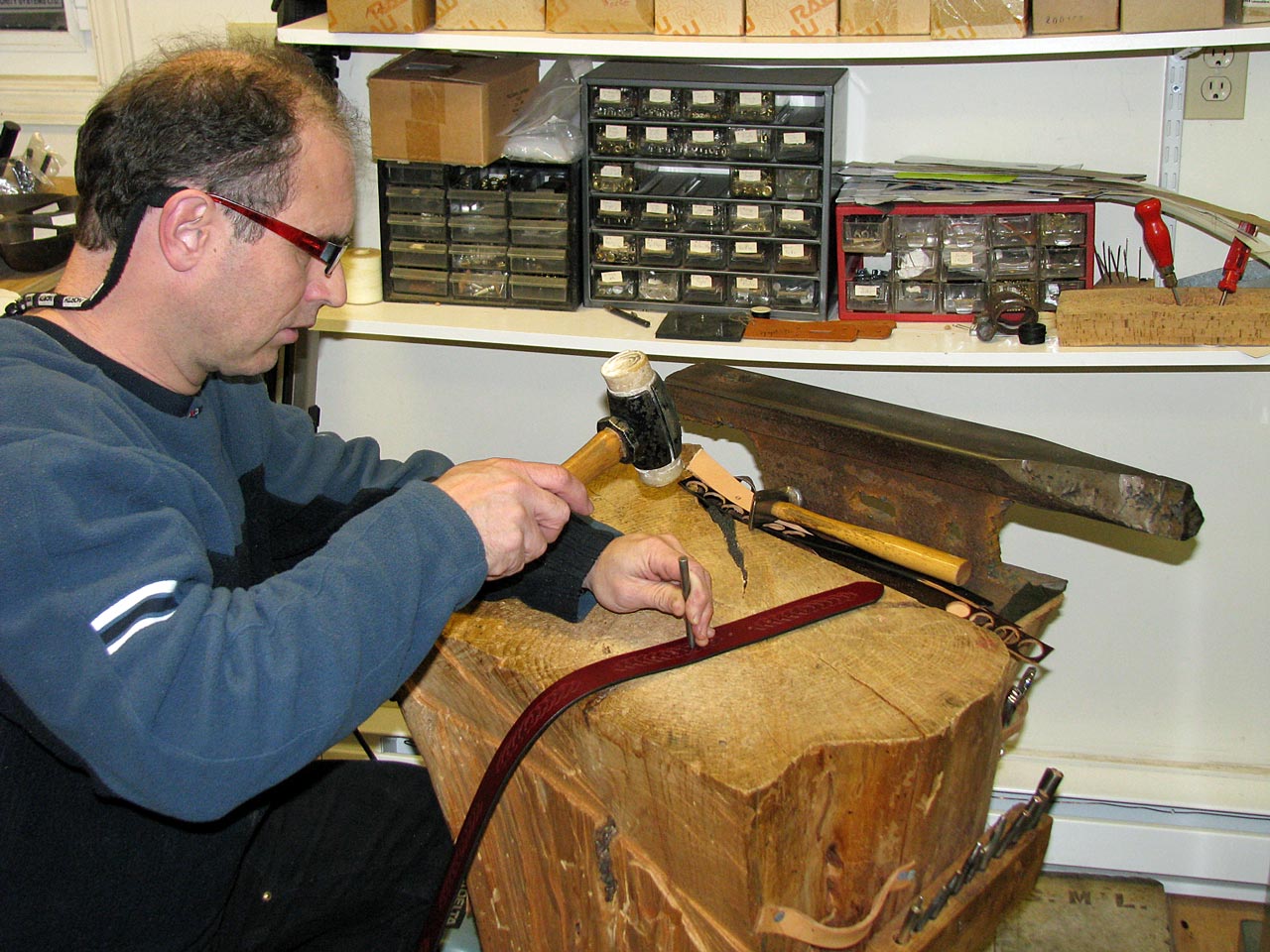 Tree stump used as work bench for punching holes, riveting and holding leather craft tools